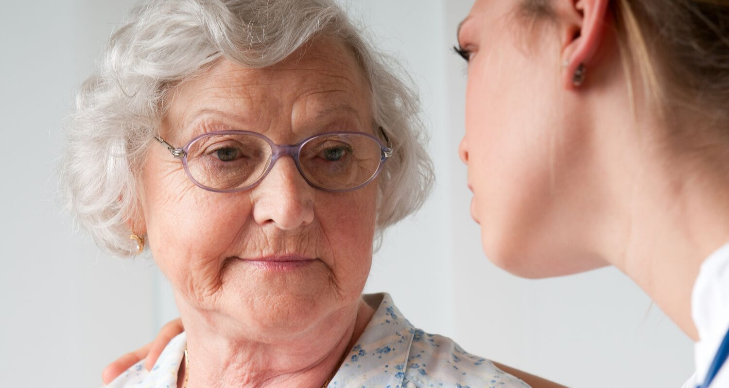 Older woman chatting with doctor