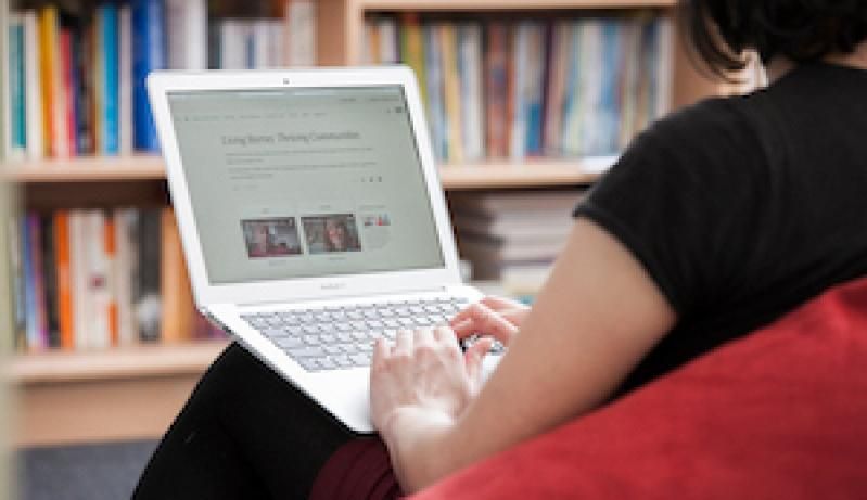 Woman looking at news on laptop